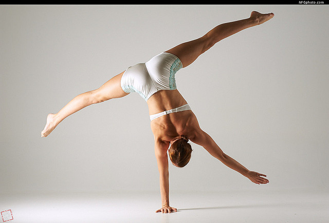 woman doing one-arm handstand