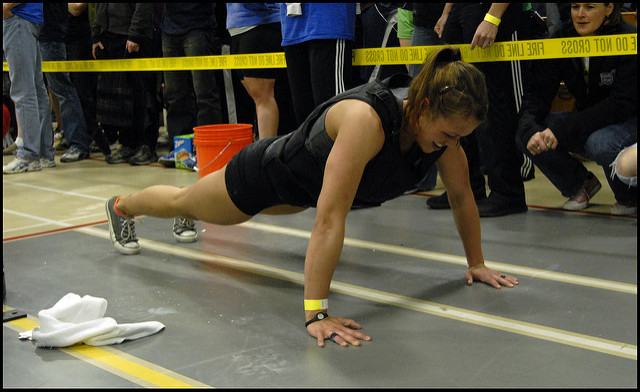 woman doing plank with weight vest