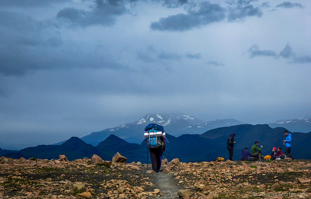 hiker atop mountain