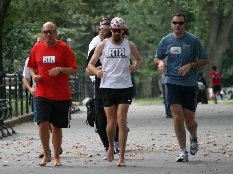 tellman running barefoot in the city