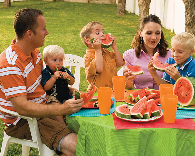family eating watermelon